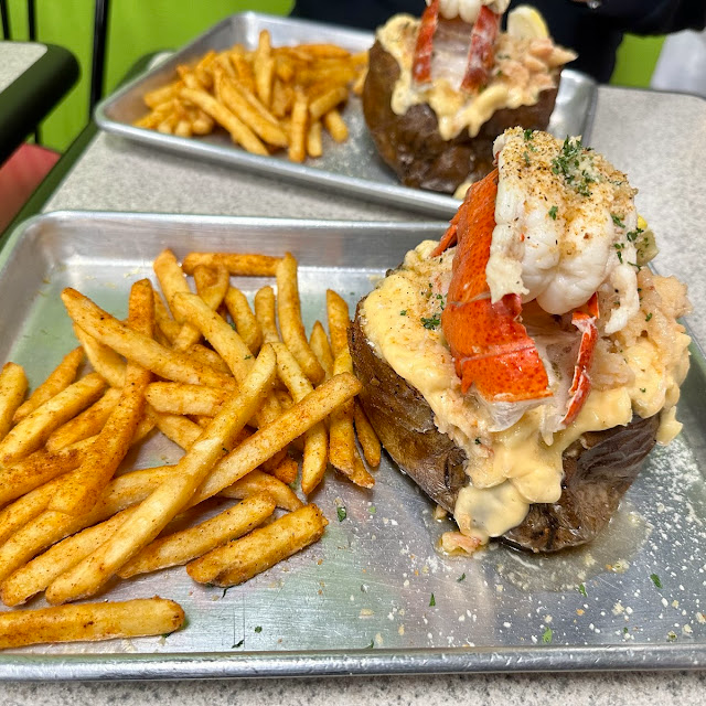 Cheese fries, thick cut fries under a generous pour of lobster bisque cheese sauce and bacon