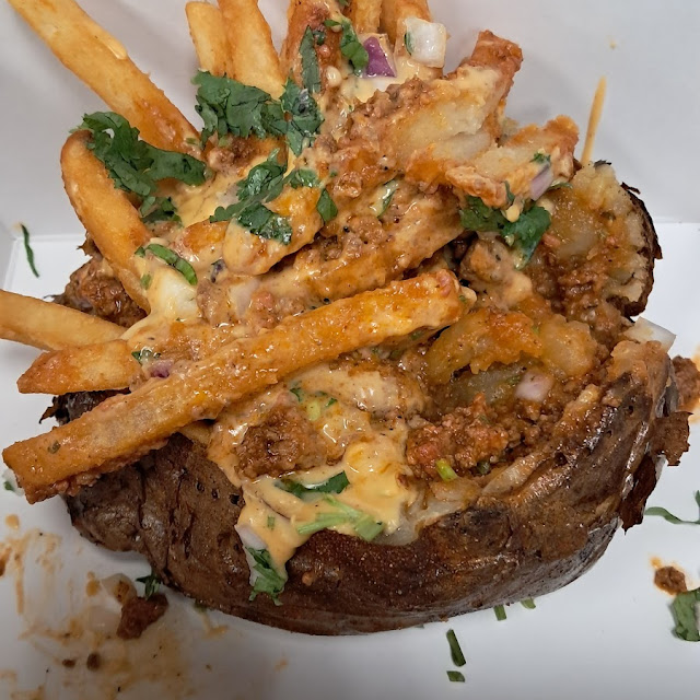 The Dirty Motley, a baked potato loaded with chorizo chili, thick cut fries, red onions, and cilantro