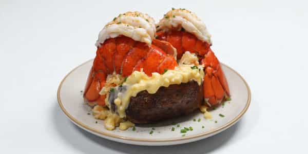 The Sugar Daddy, a baked potato loaded with two whole lobster tails, lobster mac and cheese, truffle oil, and a lemon wedge