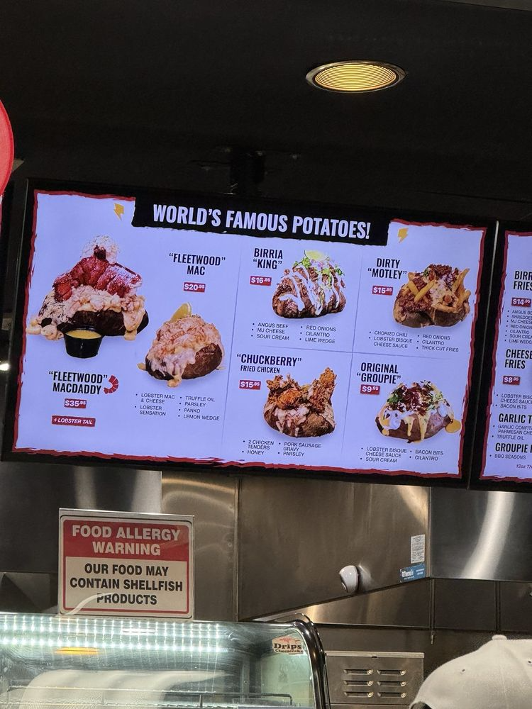 Inside the Rock N' Potato food counter at Showcase Mall, showing the full build station